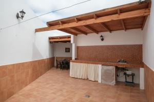 a large room with a counter and a table at Casa Abuela Nicolasa in Máguez