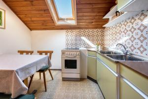 a kitchen with a sink and a stove and a table at Urthalerhof Historic in Valdaora