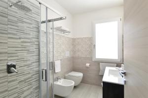 a bathroom with a toilet and a sink and a shower at Venere cala gonone vista mare in Cala Gonone