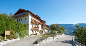 a house on the side of a road at Rafaser - Apartment Albina in Feldthurns