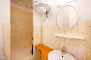 a bathroom with a sink and a mirror at Les Mimosas - Appartement 10 in Cazaubon +12 photos