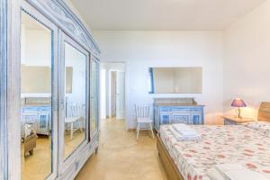 a bedroom with a bed and a table and chairs at Tenuta Belvedere Luxury e Spa in Gagliano del Capo +35 photos