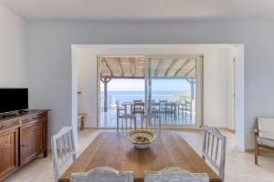 a living room with a dining room table with a view of the ocean at Tenuta Belvedere Luxury e Spa in Gagliano del Capo