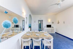 a dining room with a table and white walls at Tenuta Belvedere Luxury e Spa in Gagliano del Capo