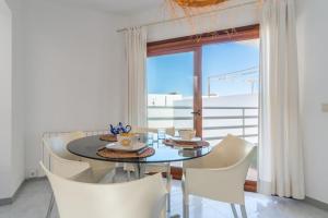 a dining room with a table and chairs and a window at Miramar in Artá +35 photos