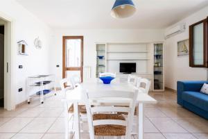 a white dining room with a white table and chairs at Case Vacanze Otranto in Otranto