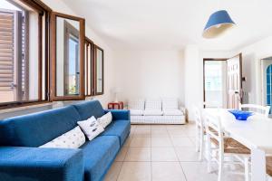 a living room with a blue couch and a table at Case Vacanze Otranto in Otranto