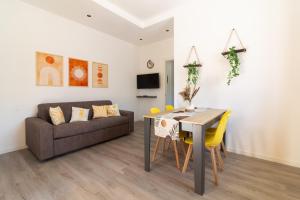a living room with a couch and a table and chairs at La Dimora di Luna in Terrasini