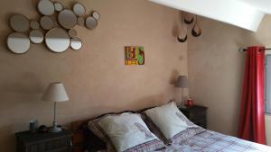 a bedroom with a bed and mirrors on the wall at Maison du Pâtre in Urbanya