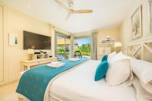 a bedroom with a large white bed with blue pillows at Villa Bellviure Luxury in Palma in Marratxí  +23 photos