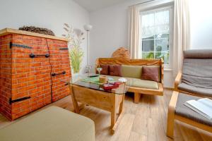 a living room with a couch and a glass table at Ferienwohnung Storchennest in Neuendorf am See