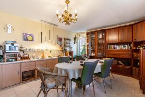 a kitchen with a table and chairs and a dining room at Haus Ursula in Ettenheim