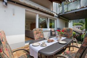 a table and chairs on a patio with a table and chairs at Haus Petra in Kandern