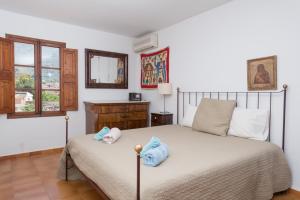 a bedroom with a bed with two towels on it at Can Guixa in Sóller +17 photos