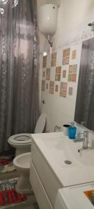 a bathroom with a toilet and a sink and a shower at Bed and Breakfast sapore da mare in Lido di Ostia +28 photos