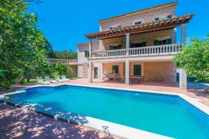 a large swimming pool in front of a house at Can Guixa in Sóller