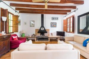 a living room with a couch and a fireplace at Can Guixa in Sóller