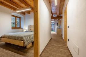 a bedroom with a bed and a hallway at Casa al Mulino 2 in Tenno