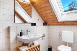 a bathroom with a sink and a skylight at Ferienwohnung Steinhart in Lenzkirch +23 photos