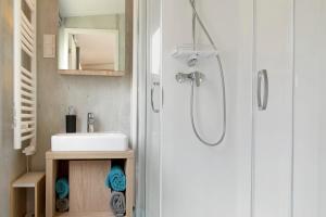 a bathroom with a shower and a sink at Tinyhouse Entspannung und Erholung in Untergriesbach +12 photos