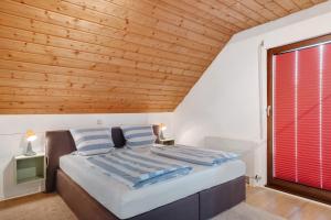 a bedroom with a bed and a wooden ceiling at Ferienwohnung Steinhart in Lenzkirch