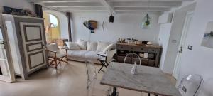 a living room with a couch and a table at il Carrubo in Finale Ligure