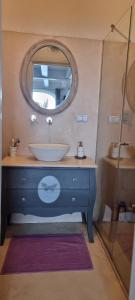 a bathroom with a sink and a mirror at il Carrubo in Finale Ligure +5 photos