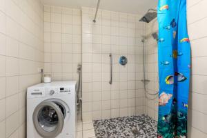 a shower stall with a washing machine in a bathroom at Alte Schule in Münsingen