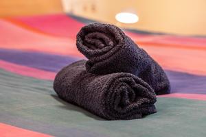 a towel is sitting on top of a bed at Alte Schule in Münsingen +23 photos