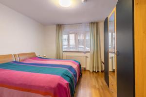 a bedroom with two beds and a window at Alte Schule in Münsingen