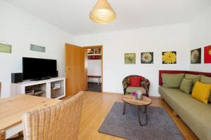a living room with a couch and a table at Ferienwohnung Bachem mit Balkon in Bad Neuenahr-Ahrweiler