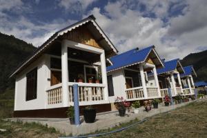 a row of houses with blue roofs at Sangti River Front Homestay in Dirang Dzong +4 photos
