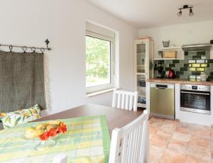 a kitchen and dining room with a wooden table at Ferienhaus Specht in Schotten +12 photos
