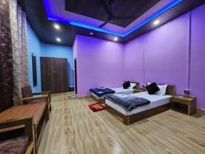 a room with a bed and a purple wall at Sangti River Front Homestay in Dirang Dzong