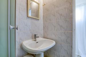 a bathroom with a sink and a mirror at Mas des Cypres - Mazet 9 in Saintes-Maries-de-la-Mer