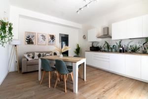 a kitchen and living room with a table and chairs at La Dimora di Luna in Terrasini