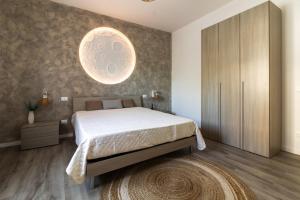 a bedroom with a bed and a large orb on the wall at La Dimora di Luna in Terrasini