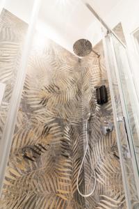 a bathroom with a shower with a patterned floor at La Dimora di Luna in Terrasini +26 photos