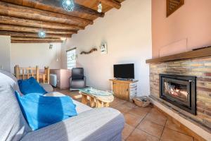 a living room with a couch and a fireplace at La Sala in Peñarroya de Tastavins
