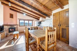 a kitchen and dining room with a wooden table and chairs at La Sala in Peñarroya de Tastavins +18 photos