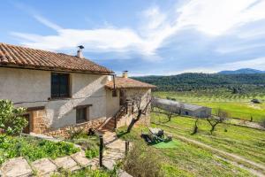 a stone house with a view of a field at La Sala in Peñarroya de Tastavins