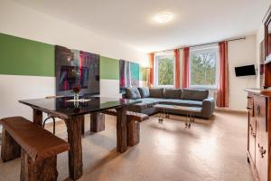 a living room with a table and a couch at Kolbatzer Mühle in Lychen