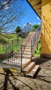 a staircase with a metal railing next to a building at Casa Vanda in Orte +7 photos