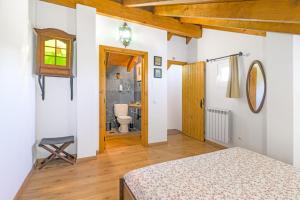 a bedroom with a bed and a bathroom at Alquimia, Alchemy, Alchimie in São Luis +27 photos