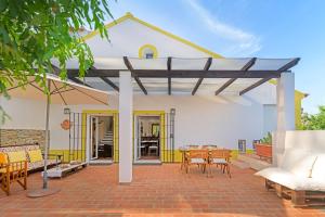 a patio with a roof with a table and chairs at Alquimia, Alchemy, Alchimie in São Luis