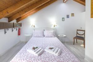 a bedroom with a large bed with two white chairs at Alquimia, Alchemy, Alchimie in São Luis