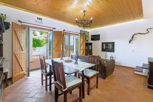 a dining room and living room with a table and chairs at Alquimia, Alchemy, Alchimie in São Luis