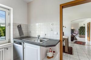 a kitchen with a sink and a counter top at Ferienwohnung Auszeit Sauerland in Meinerzhagen +21 photos