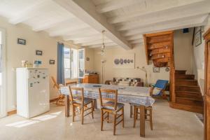 a kitchen and dining room with a table and chairs at Isatis in Mortagne-sur-Gironde
