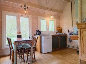 a kitchen with a table and a white refrigerator at Vakantiewoning Moerweie GR04 in Grijpskerke +14 photos